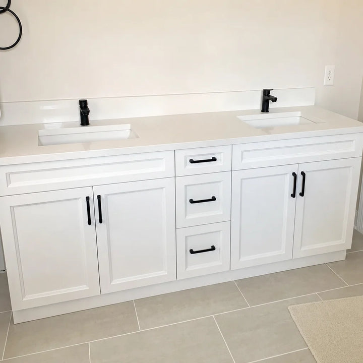 Tesoro 60-inch white double sink Shaker solid wood bathroom vanity with black handles in a spacious bathroom with large-format tile floor