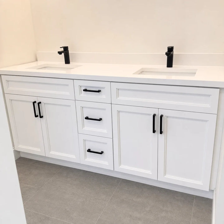 Tesoro 60-inch white double sink Shaker solid wood bathroom vanity with black handles in a bathroom with travertine stone tile floor