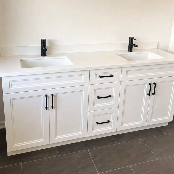 Tesoro 72-inch white double sink Shaker solid wood bathroom vanity with black handles in a freshly renovated bathroom with slate tile floor