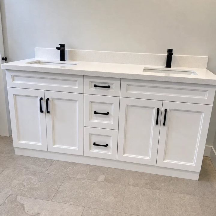 Tesoro 72-inch white double sink Shaker solid wood bathroom vanity with black handles in a contemporary bathroom with natural stone floor