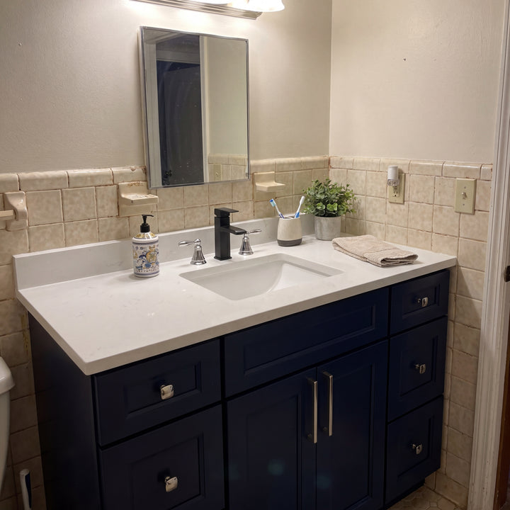 Tesoro 48" Blue Shaker vanity under a round mirror in a Canadian bathroom