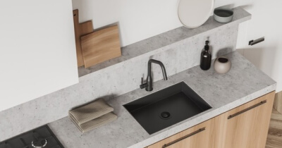 home care supply kitchen sink with a sleek black sink and a wooden counter